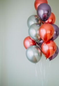 Vibrant group of red and silver balloons providing festive copyspace.